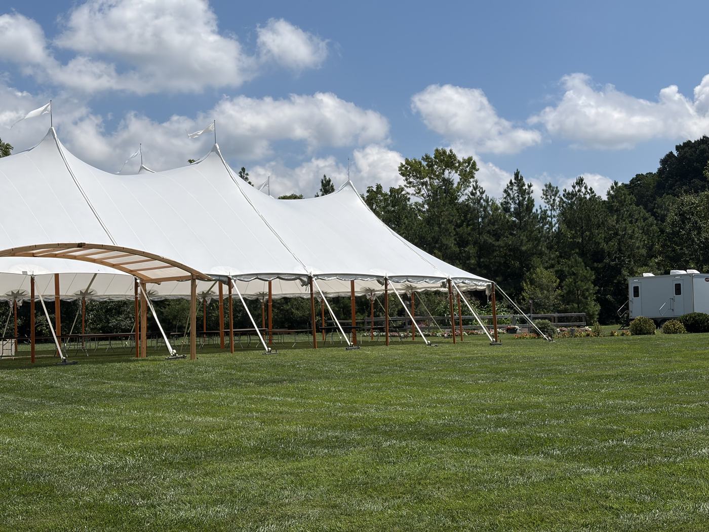 Clean Spot restroom trailer set up beside a sailcloth tent at a Maryland wedding reception