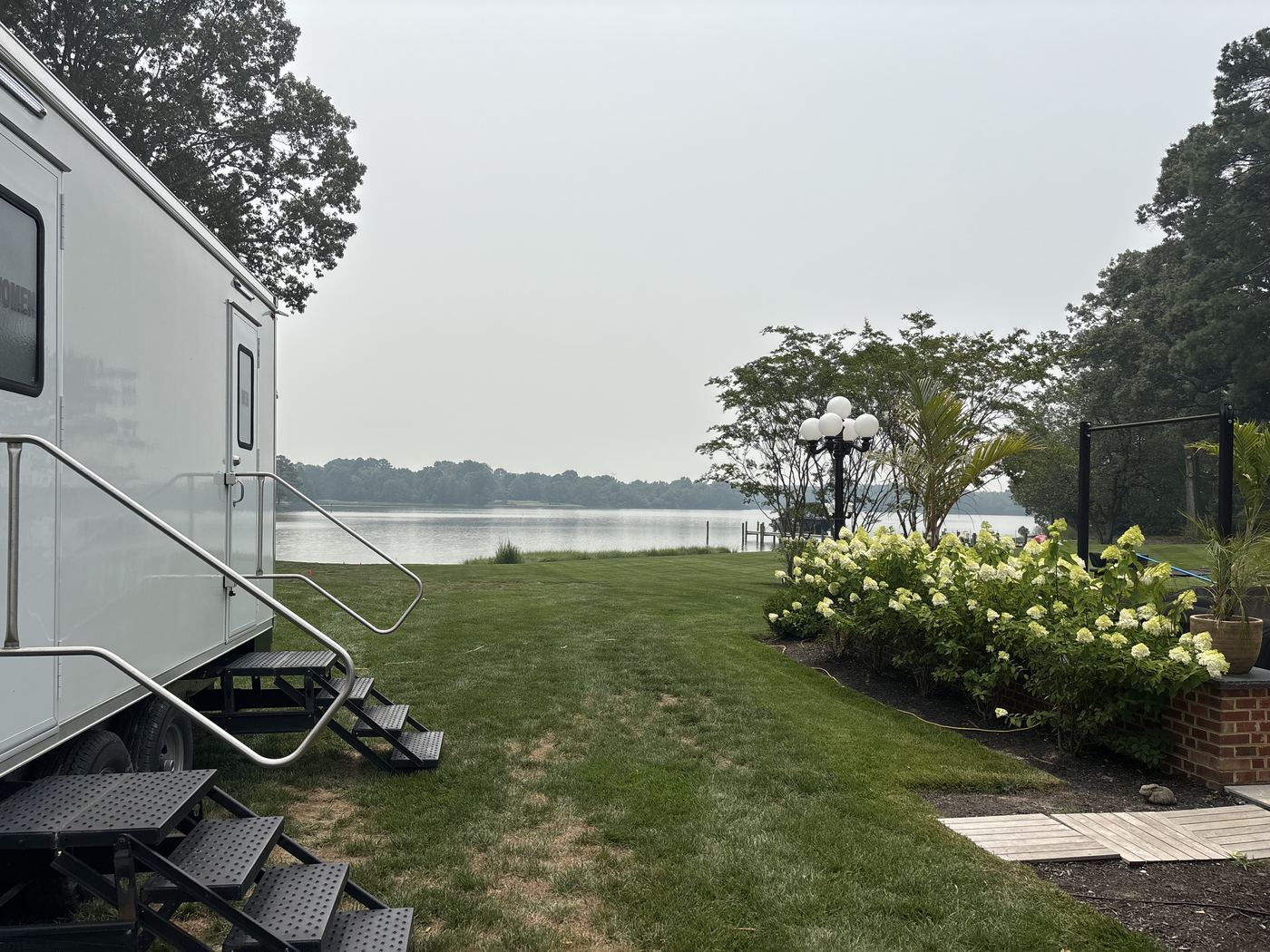 Wedding restroom trailer set up on a waterfront lawn at a private Eastern Shore estate